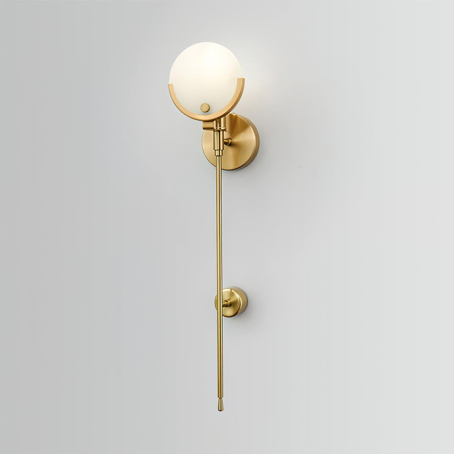 The Clérachic wall light on a pale wall, round backplate, globe shade and long stem with its mid-point clip.