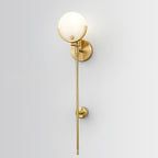 Clérachic sconce shown closer on the same pale wall, the brushed brass finish reading warm against the white.