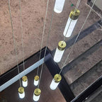 The Clérachic Zeal cascade photographed from above on a marble stair, each alabaster tube glowing along its length.