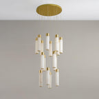 Clérachic Zeal chandelier viewed almost head-on, the tiered cluster of stone tubes compressed under the brass disc.
