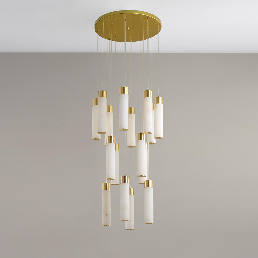 Clérachic Zeal chandelier viewed almost head-on, the tiered cluster of stone tubes compressed under the brass disc.