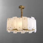 The ten-light Clérachic Zoe alabaster chandelier seen head-on, the staggered stone panels lit from within above a brass spoke frame.
