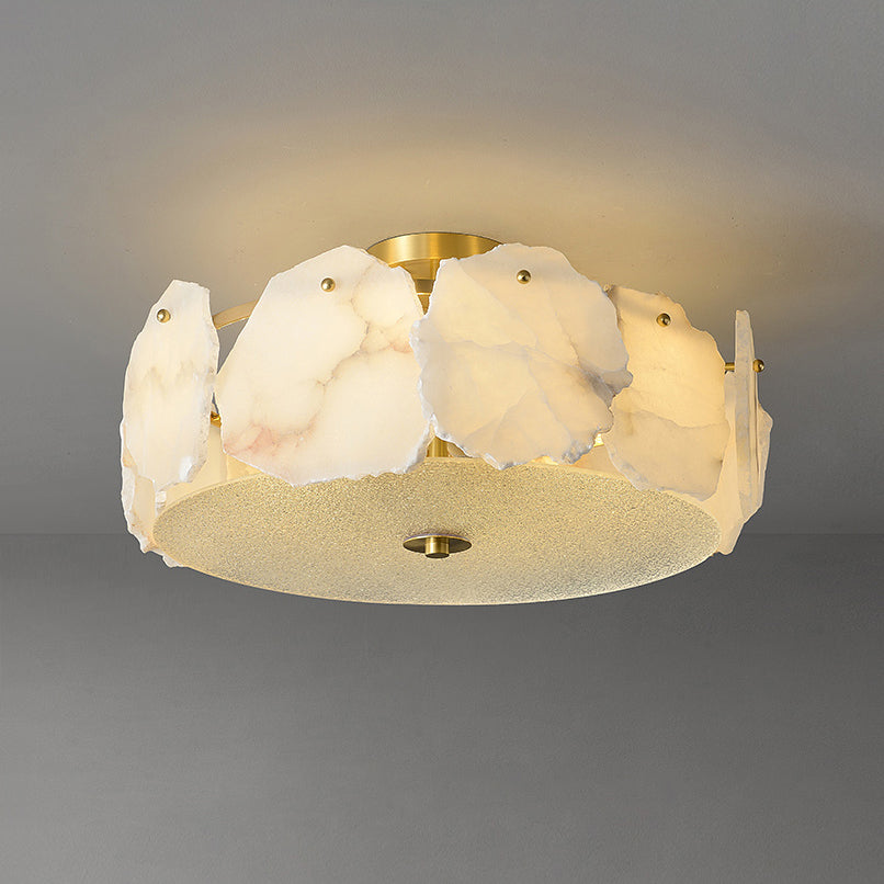 The Clérachic disc ceiling light seen closer, alabaster panels overlapping around a frosted glass underplate.