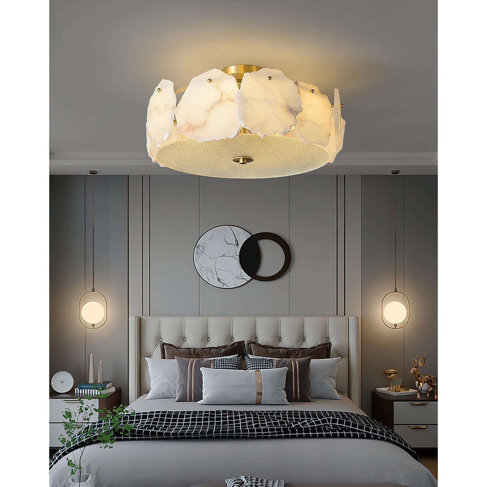 The Clérachic ceiling light centred over a bed flanked by two round pendants and a marble wall mirror.