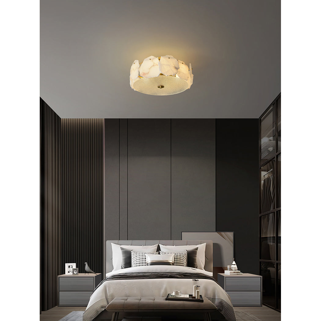 Clérachic flush mount seen from across a dark bedroom, a small warm disc against the pale ceiling.