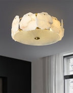 The Clérachic ceiling light beside black wardrobe doors, daylight from the window catching its brass rim.