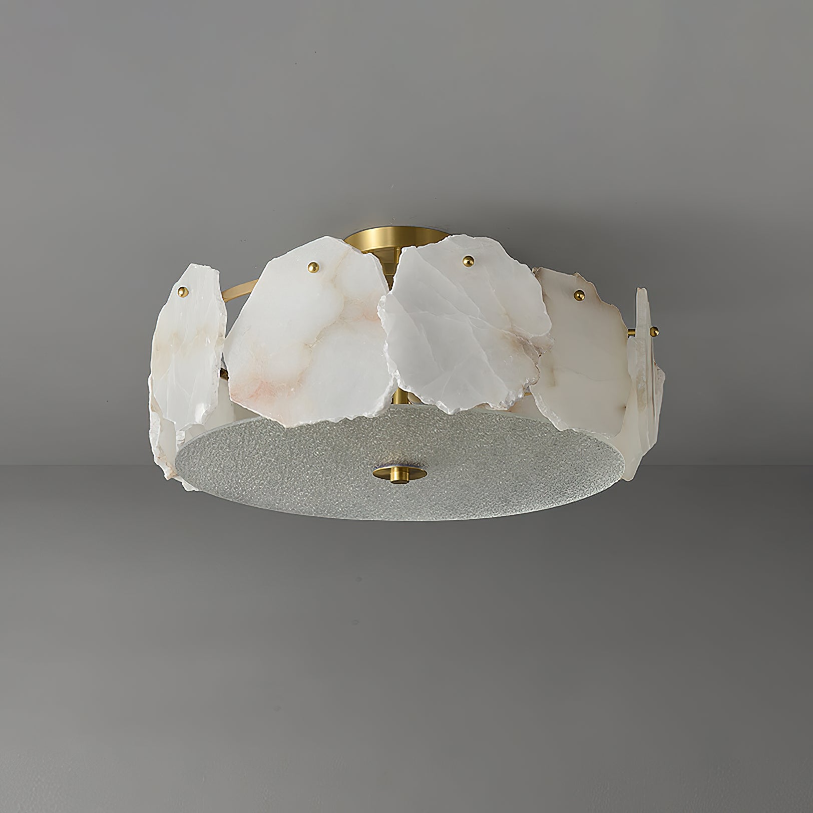 Clérachic disc ceiling light from below and to one side, the textured glass underplate reading pale grey.