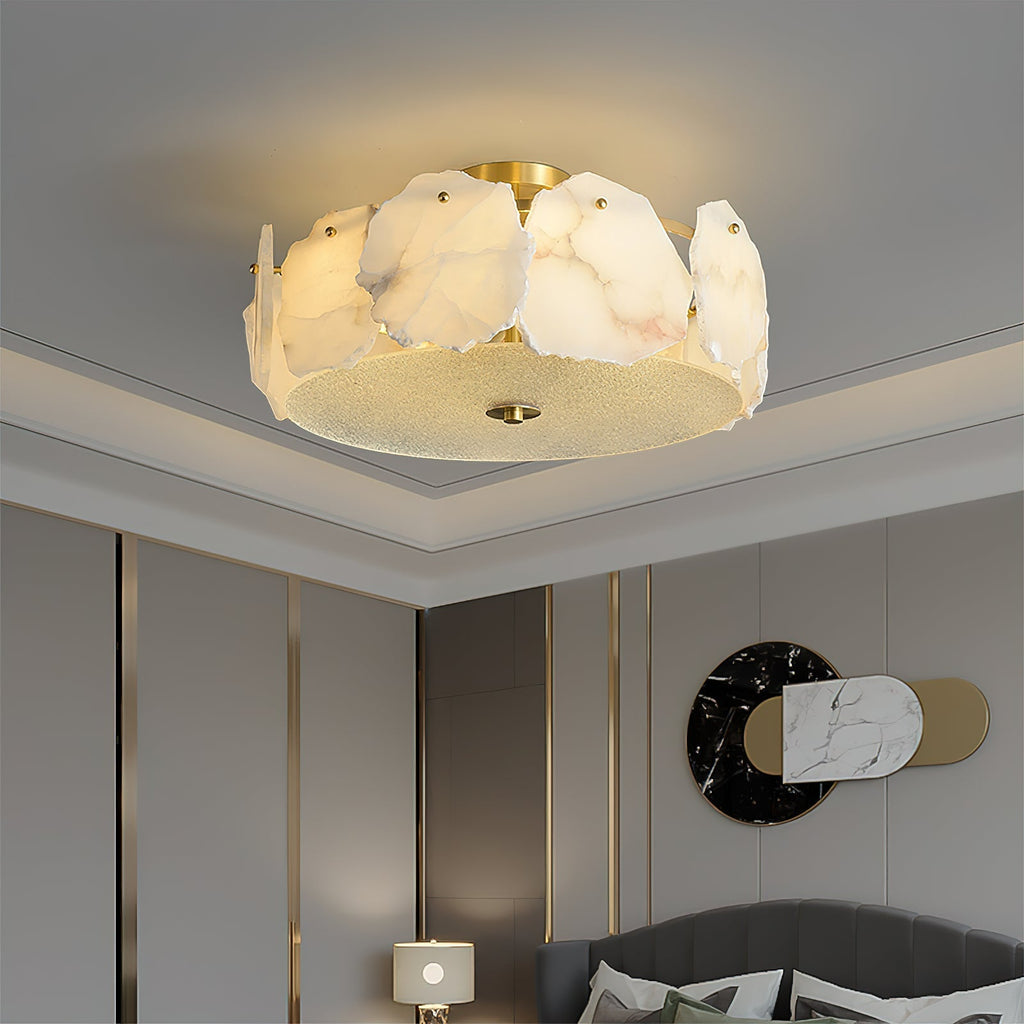The Clérachic flush mount in a room trimmed with slim gold mouldings, its alabaster ring picking up the brass.