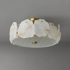 Clérachic ceiling light shown side-on, the alabaster slabs standing proud of the frosted glass base disc.