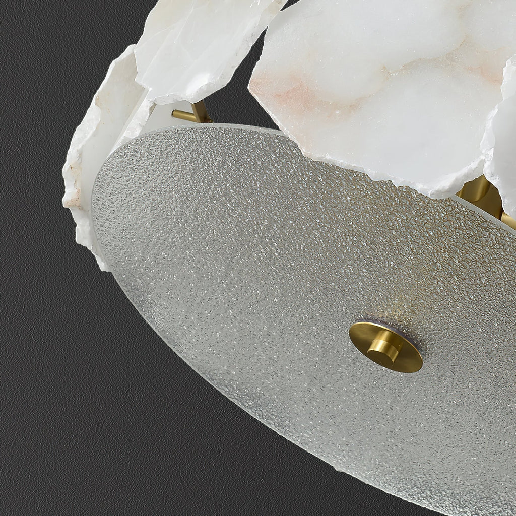 Close view of the Clérachic light's textured glass underplate, finished with a turned brass finial at its centre.