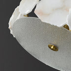 Close view of the Clérachic light's textured glass underplate, finished with a turned brass finial at its centre.