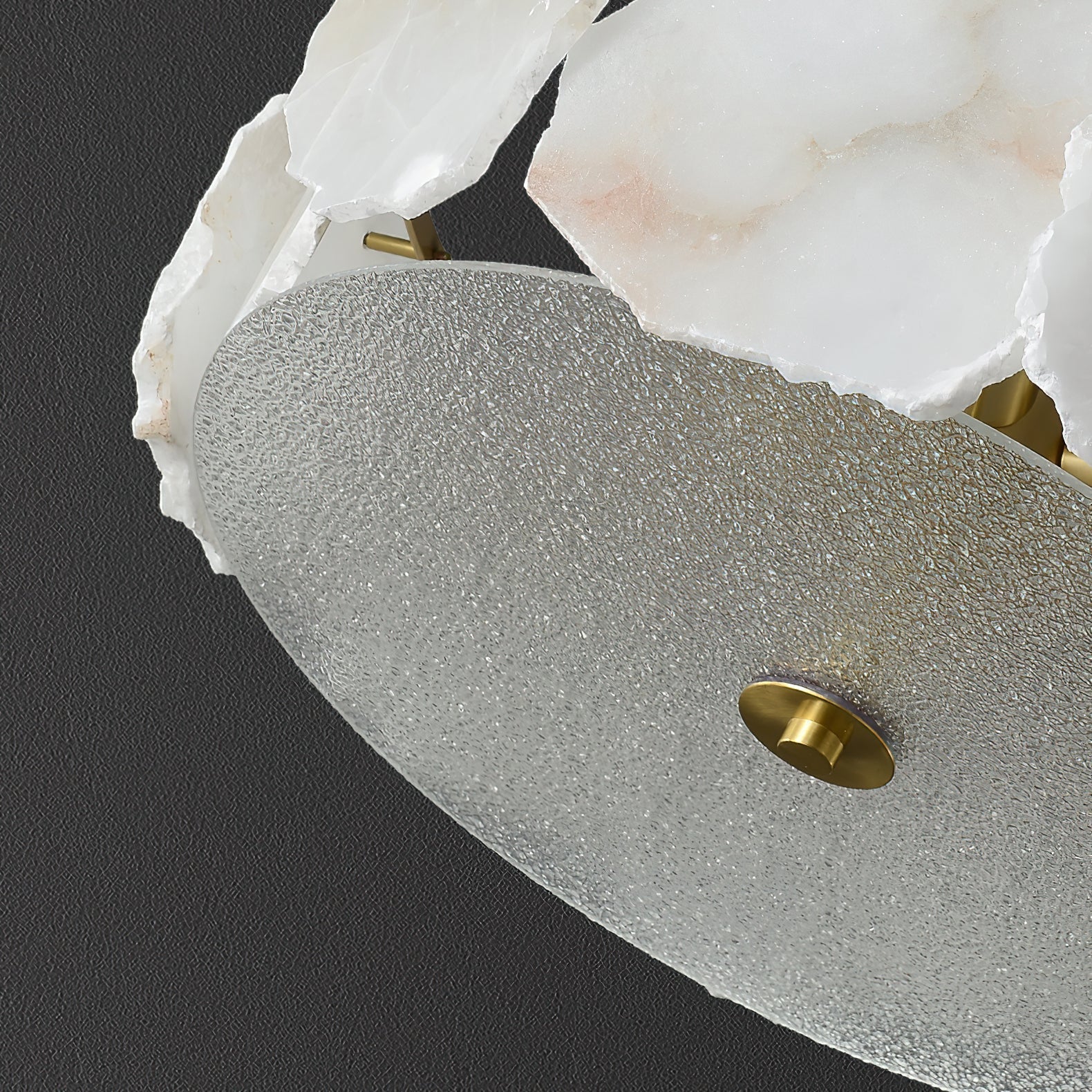 Close view of the Clérachic light's textured glass underplate, finished with a turned brass finial at its centre.