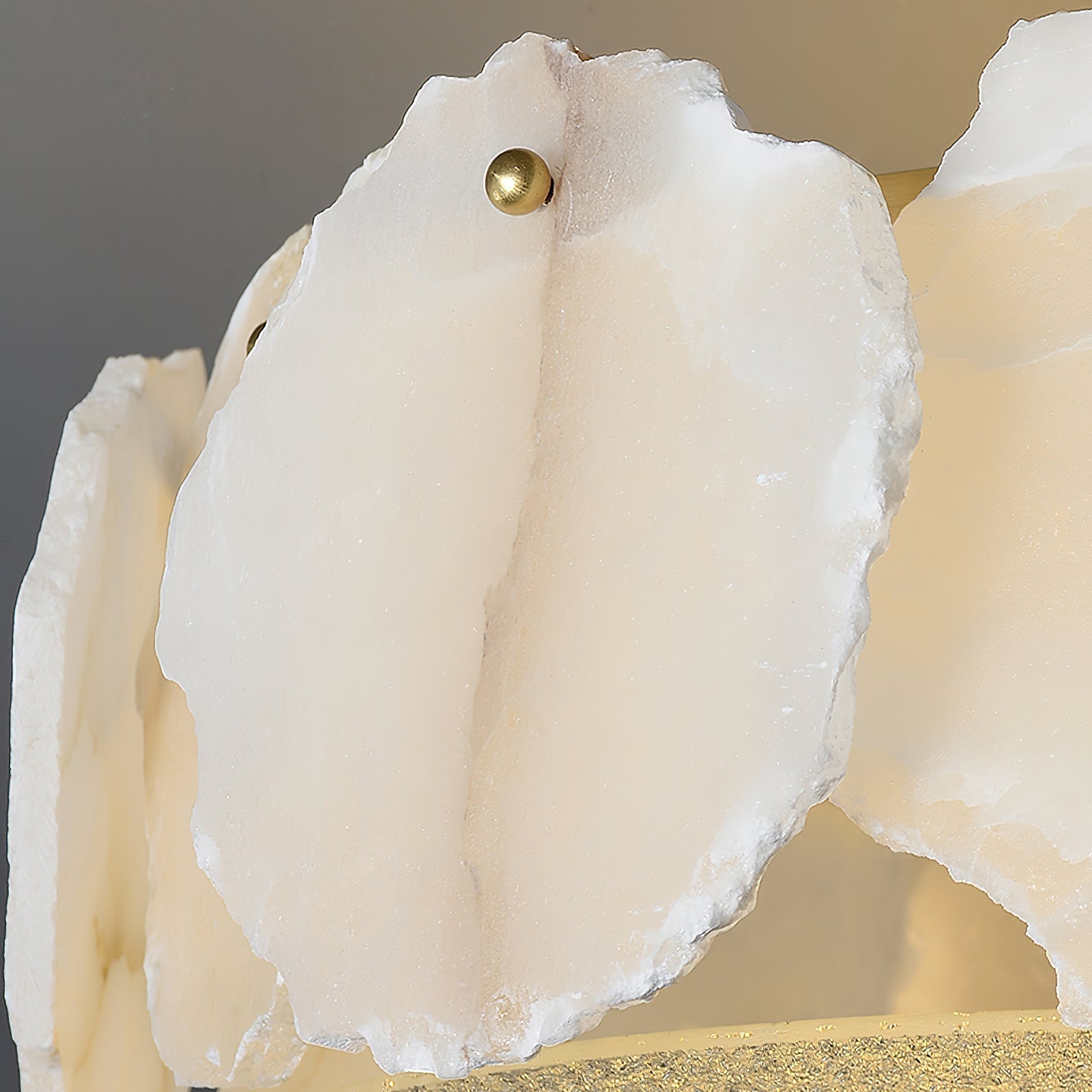 A single alabaster panel on the Clérachic ceiling light, veined and translucent, fixed with a brass ball stud.