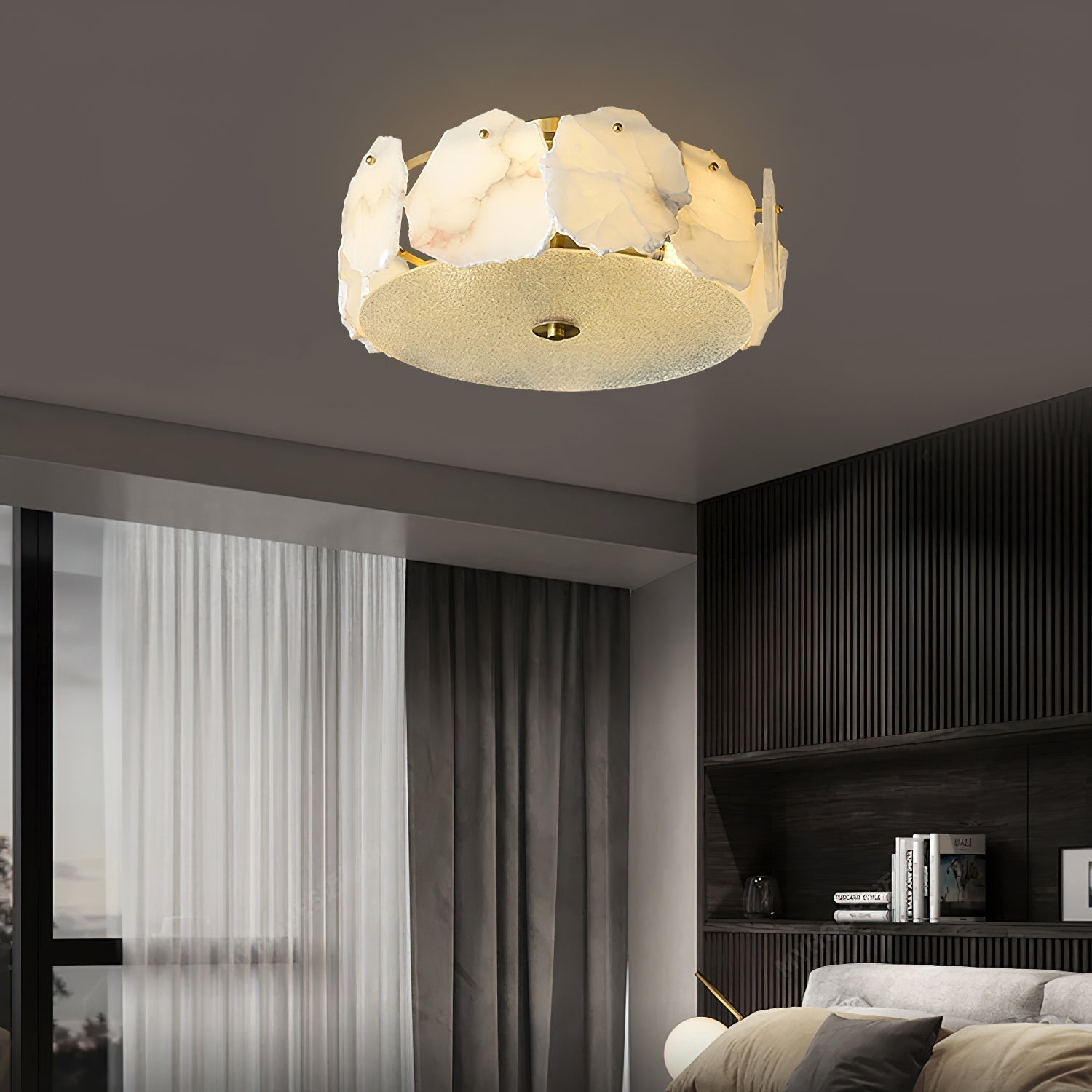 The Clérachic ceiling light in a dim room with heavy curtains, its alabaster ring the brightest point.
