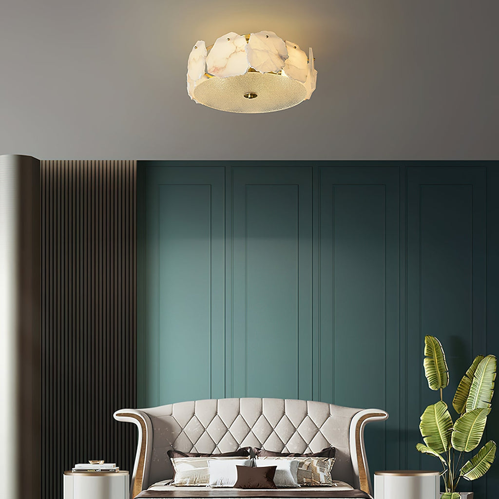 Clérachic flush mount over a tufted sofa against a deep teal panelled wall, brass fittings warm-toned.