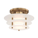 Clérachic Zovena semi-flush ceiling light seen from below at an angle, its three alabaster discs stepping out beneath a round brass canopy.