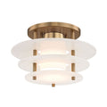 The Zovena tiered alabaster ceiling light from Clérachic, lit, with soft light escaping the narrow gaps between its three stone discs.