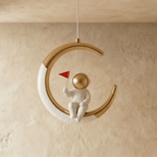 Clérachic moon pendant light in gold, the astronaut figure and glowing edge shown from another angle.