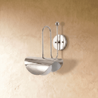 Clérachic curved-arm wall sconce in polished chrome, shown from a slightly closer studio angle on a plaster wall.