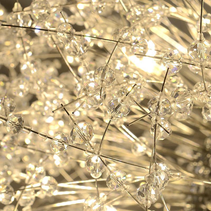 Close-up of the fine crystal-tipped wire branches on this Clérachic chandelier, warmly lit from within.