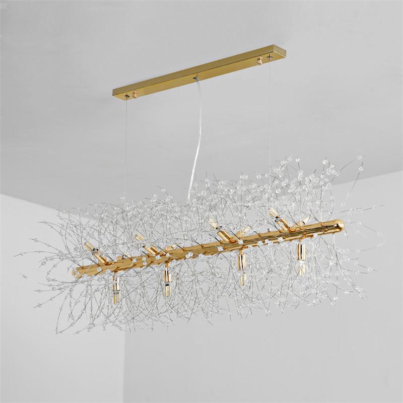 Product shot of a gold-finish rectangular bar pendant on a plain grey backdrop, a different Clérachic fixture from this chandelier.