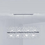 Product shot of a chrome-finish rectangular bar pendant on three cables, a different Clérachic fixture from this chandelier.