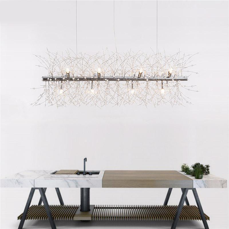Product shot of a chrome-finish rectangular bar pendant on a marble-look surface, a different Clérachic fixture from this chandelier.