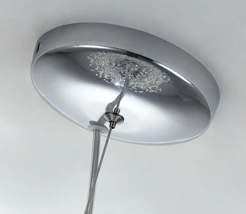 Close view of the chrome ceiling canopy and cord on this Clérachic chandelier against a plain backdrop.