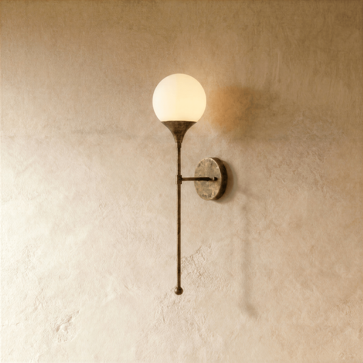 Clérachic wall lamp in vintage brass with a round frosted glass globe on a slender tapering stem.