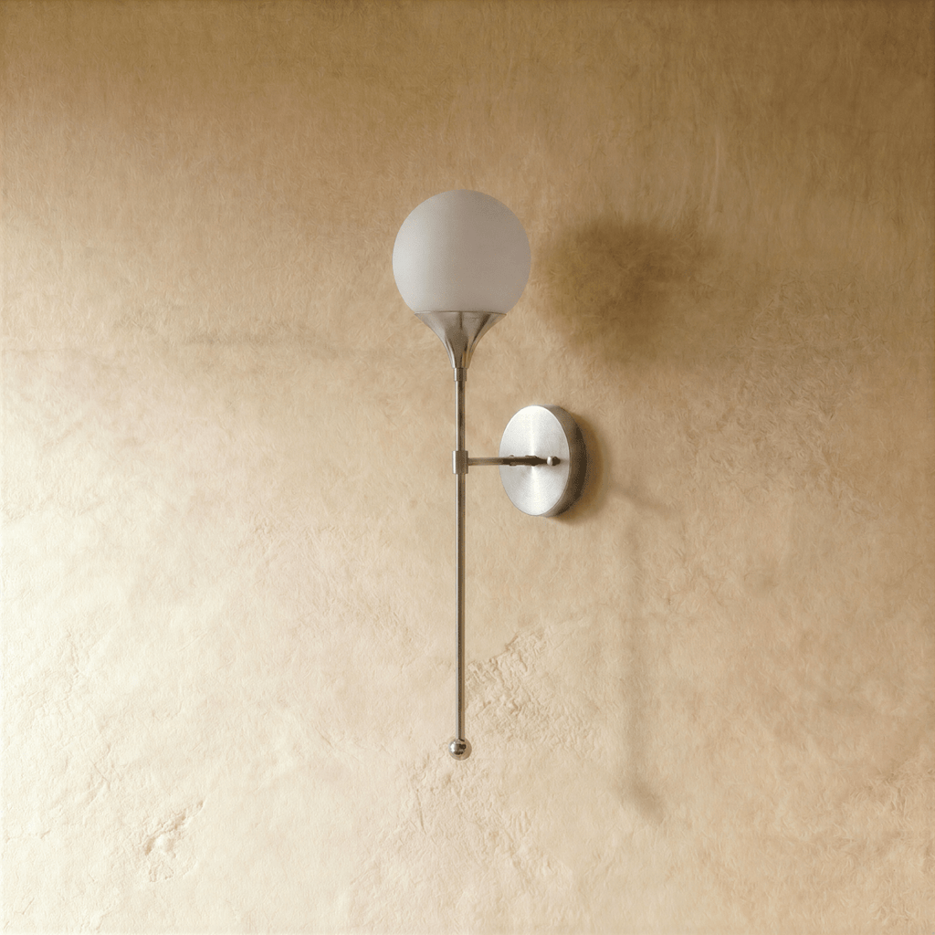 Clérachic wall lamp in chrome, front view of the glass globe shade and its slim mounting arm.
