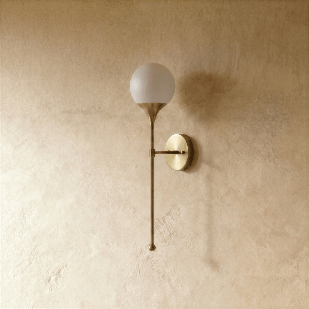 Clérachic wall lamp in satin brass, front view of the glass globe shade and its tapering rod.