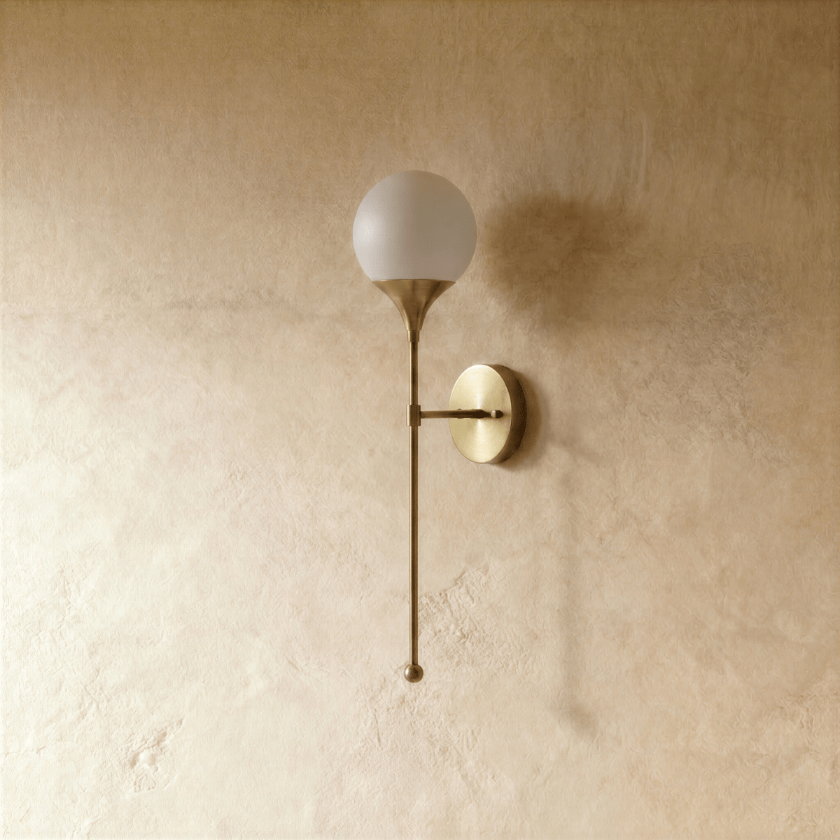 Clérachic wall lamp in satin brass, front view of the glass globe shade and its tapering rod.