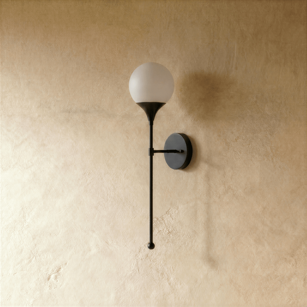 Clérachic wall lamp in matte black, close view of the glass globe and its slim mounting arm.