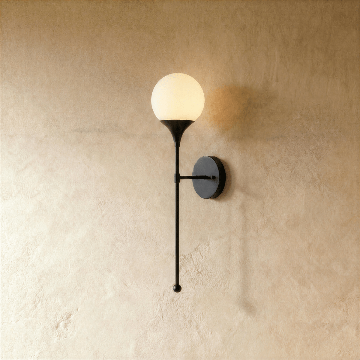 Clérachic wall lamp in matte black with a round frosted glass globe on a slender tapering stem.