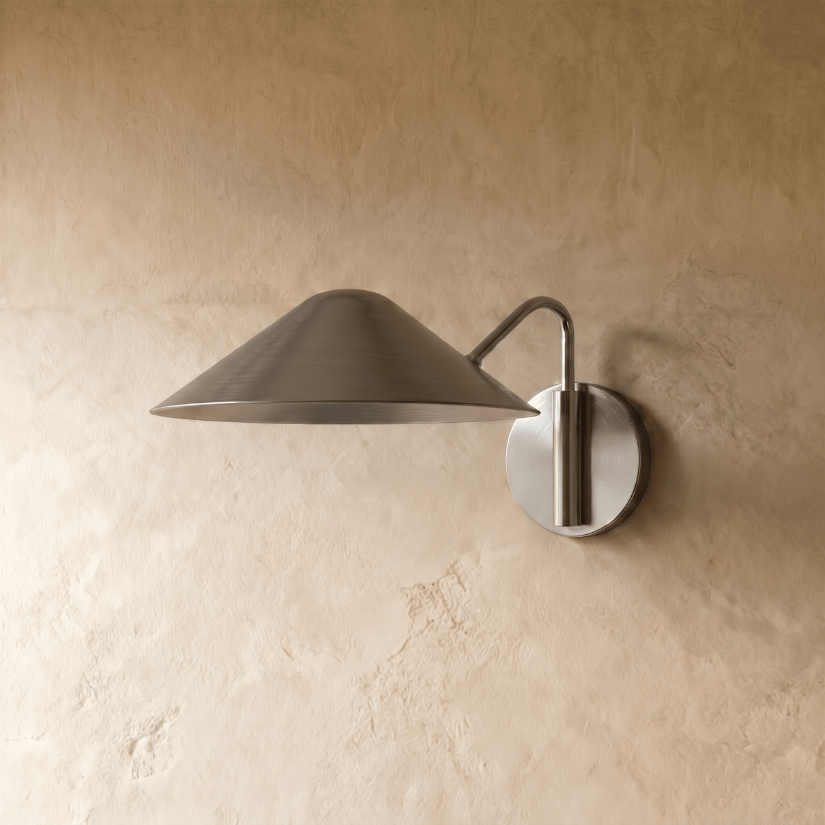 Clérachic cone-shade wall sconce in chrome, shown from a slightly closer studio angle on a plaster wall.