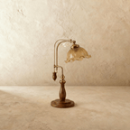 Clérachic table lamp in amber glass, the fluted shade and adjustable brass arm shown from another angle.