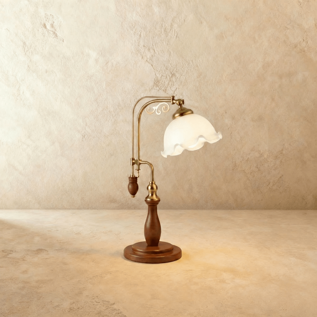 Clérachic table lamp with a ruffled milky glass shade glowing on an adjustable brass and wood arm.
