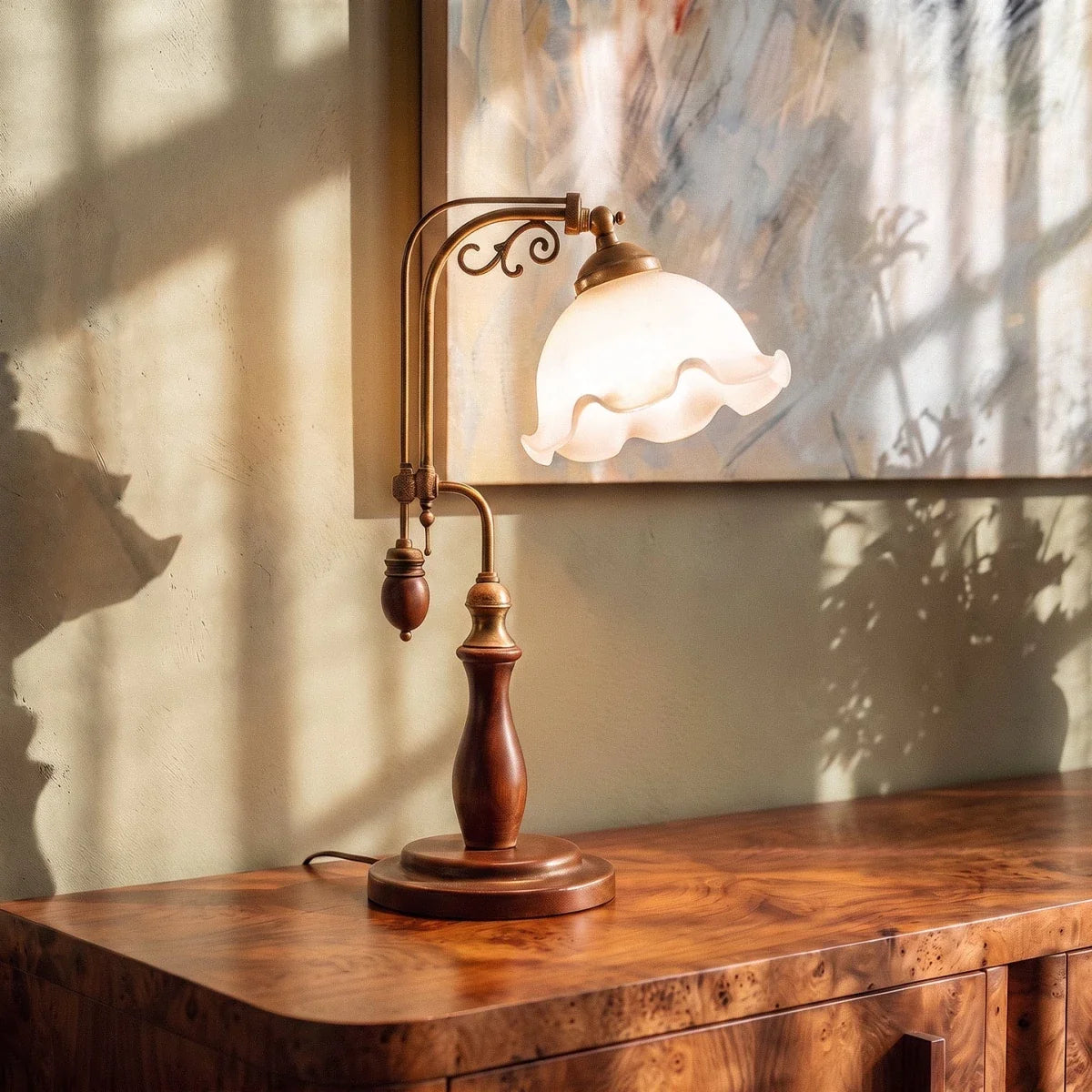 Clérachic table lamp in milky glass, a closer view glowing on a burl wood credenza in warm light.