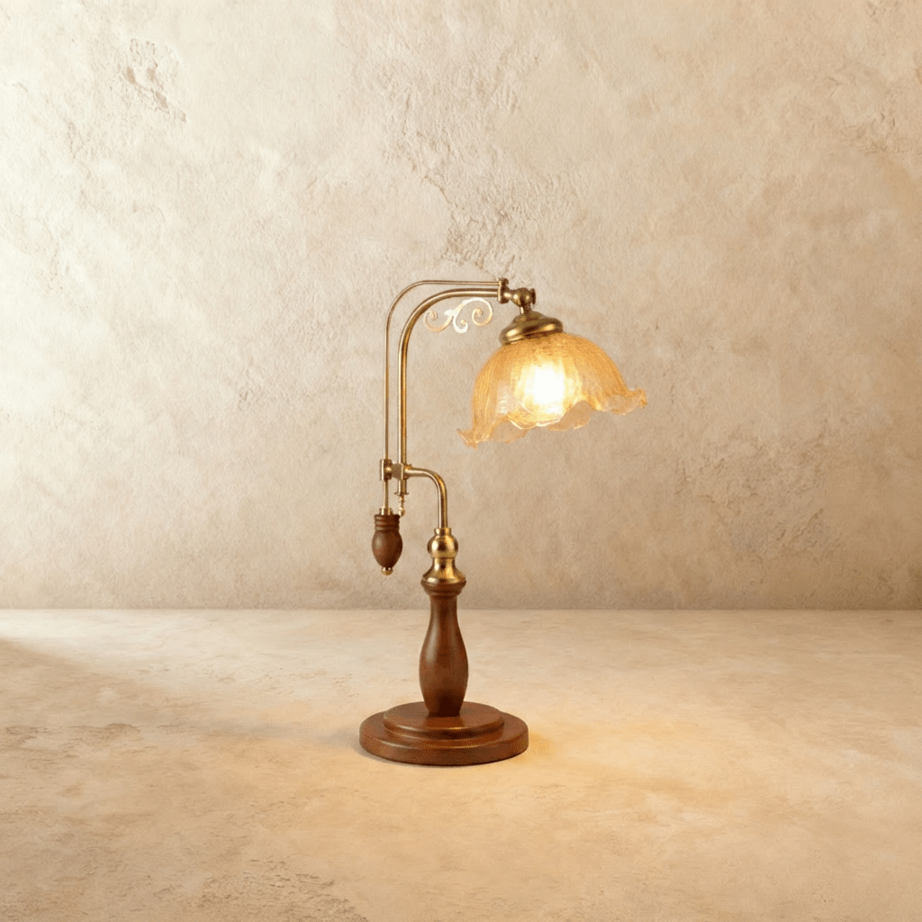 Clérachic table lamp with a fluted amber glass shade glowing warm on an adjustable brass and wood arm.