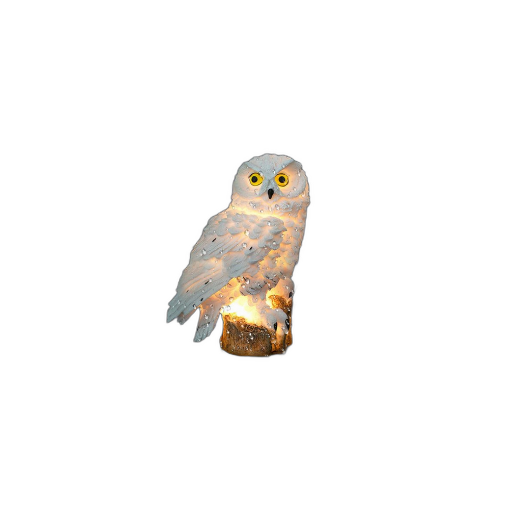 Solar owl garden light glowing warm white at its base, shown on a white background
