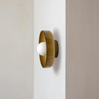 A brown-toned disc light mounted on a wall corner, a different mount from this Clérachic ceiling light.
