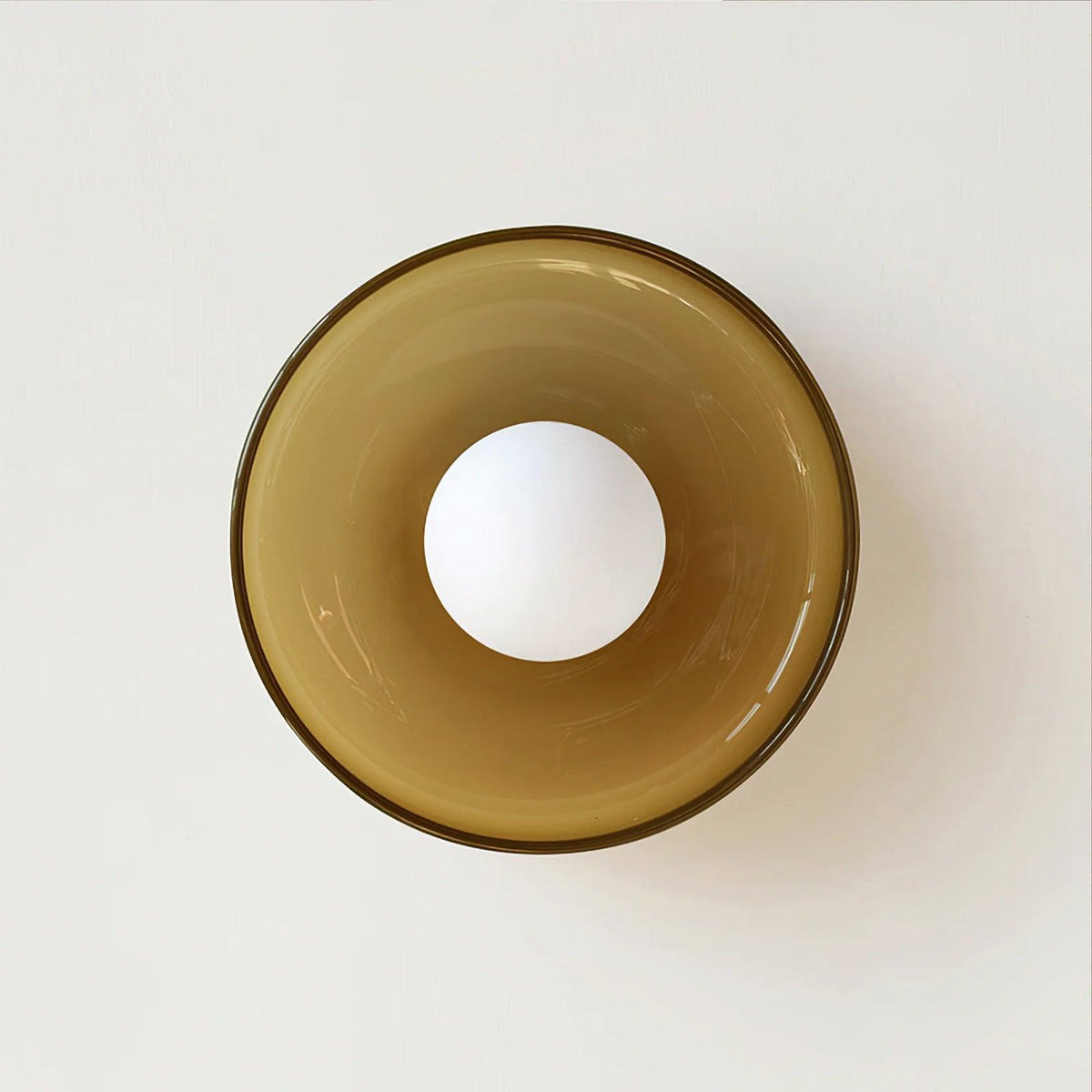 A large brown-toned wall light shown close up with its ball lit, a different fixture from this Clérachic ceiling light.