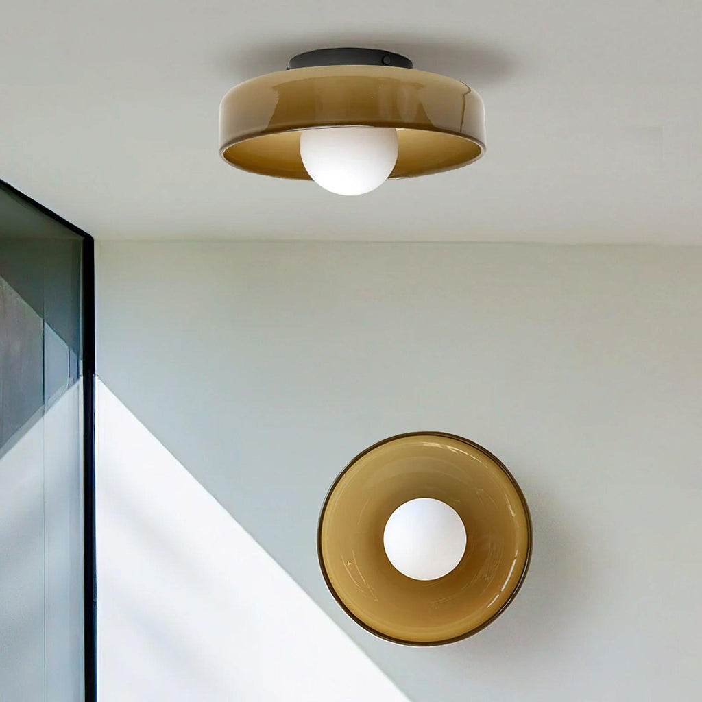 This Clérachic ceiling light and a matching wall light share a stairwell with a glass panel, both in warm brown glass.