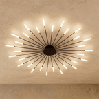 Clérachic starburst chandelier in black, a dense even ring whose tips settle on two clear circles of light.