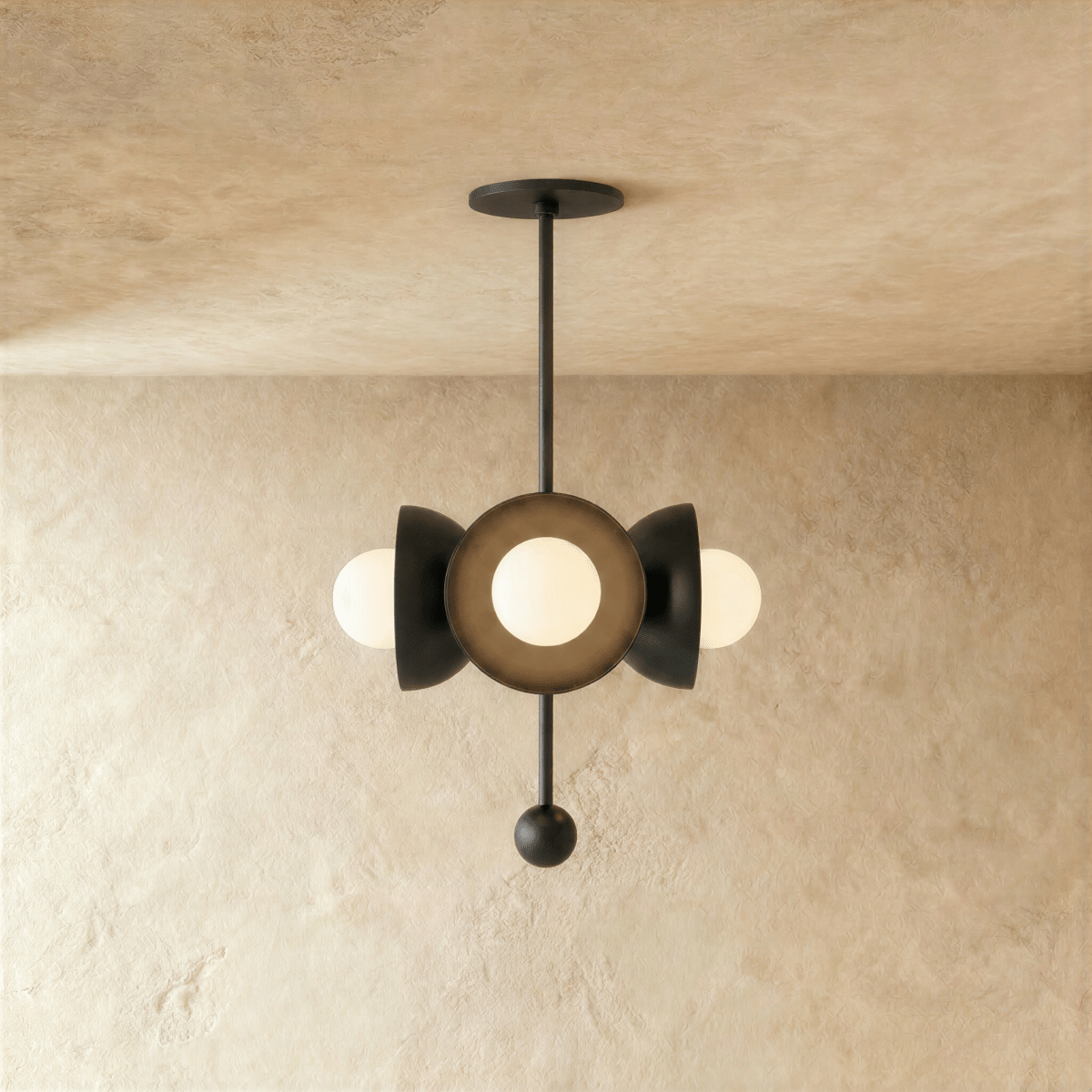 Clérachic disc-and-globe pendant light in matte black, hung from a plaster ceiling and photographed in studio.