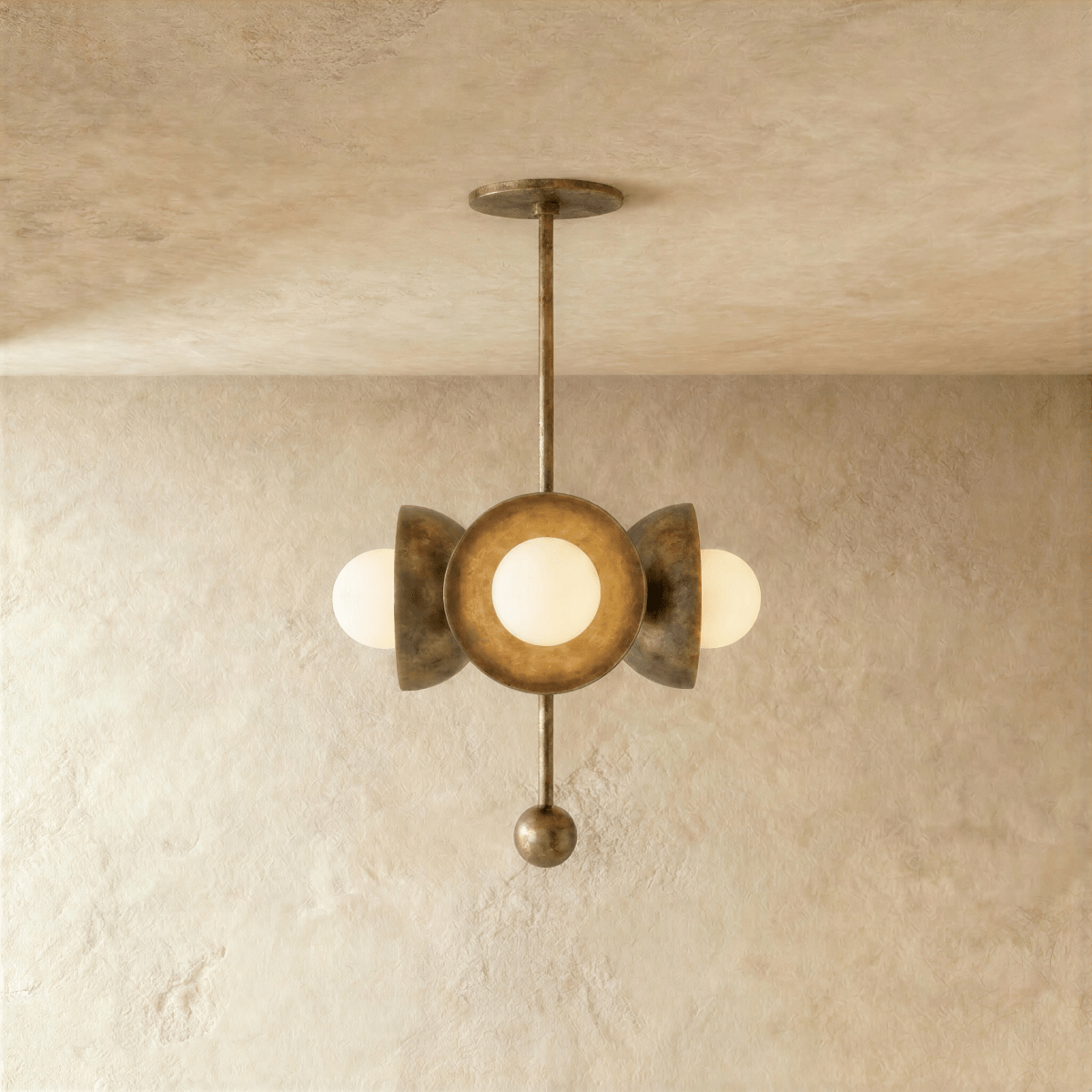 Clérachic disc-and-globe pendant light in vintage brass, hung from a plaster ceiling and photographed in studio.