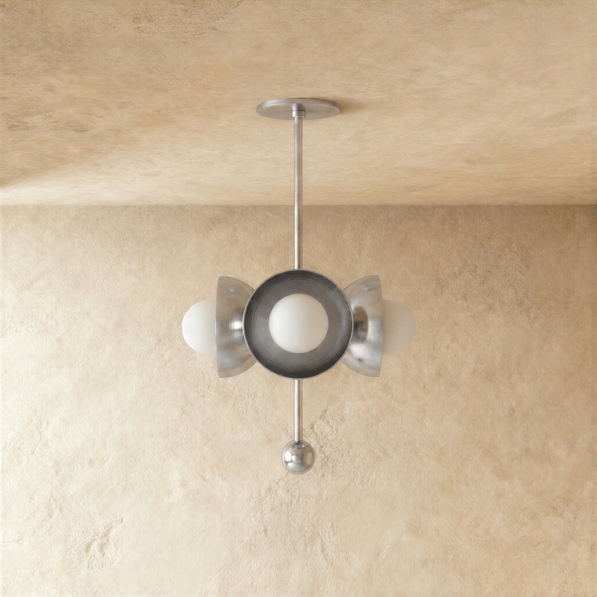 Clérachic disc-and-globe pendant light in chrome, shown from a slightly closer studio angle on a plaster wall.