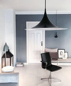 Arch pendant light hanging in a minimal dining space