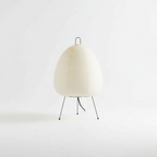 Detail of the slim three-legged metal base of the rice paper lamp