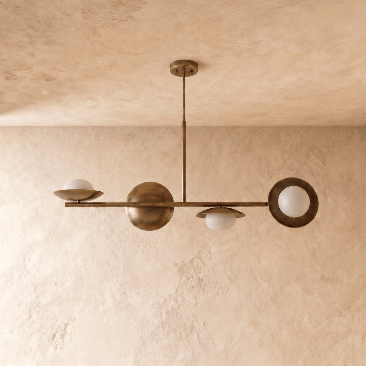 Clérachic pendant light in vintage brass, the linear brass bar and glass globes shown from a slightly wider angle.